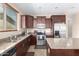 Modern kitchen boasts stainless steel appliances, granite countertops, and a center island at 35654 N Vidlak Dr, San Tan Valley, AZ 85143