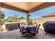 An inviting covered patio furnished with a dining table, grill, and outdoor kitchen area at 35654 N Vidlak Dr, San Tan Valley, AZ 85143