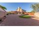 Expansive backyard features green grass and gravel, basketball hoop, and is bordered by a wooden fence and block wall at 3805 E Desert Flower Ln, Phoenix, AZ 85044
