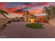 Large backyard featuring gravel landscaping, mature trees, and a grassy area for recreation at 3805 E Desert Flower Ln, Phoenix, AZ 85044