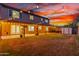 Spacious backyard featuring a covered patio, lush lawn, and charming string lights for evening enjoyment at 3805 E Desert Flower Ln, Phoenix, AZ 85044