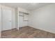 Well-lit bedroom with wood-look tile flooring and a closet with shelving providing practical space at 3805 E Desert Flower Ln, Phoenix, AZ 85044