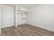 Functional bedroom with wood-look tile flooring and a closet with shelving offering efficient storage at 3805 E Desert Flower Ln, Phoenix, AZ 85044