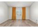 Bedroom with wood-look tile flooring and window with yellow curtains at 3805 E Desert Flower Ln, Phoenix, AZ 85044