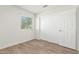Comfortable bedroom with wood-look tile flooring, a window, and a closet with sliding doors, maximizing space at 3805 E Desert Flower Ln, Phoenix, AZ 85044