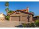 Beautiful home featuring a wide driveway, lush landscaping, and a convenient three-car garage at 3805 E Desert Flower Ln, Phoenix, AZ 85044