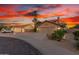 Beautiful home featuring a wide driveway, lush landscaping, and a convenient three-car garage at 3805 E Desert Flower Ln, Phoenix, AZ 85044