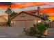 Beautiful home featuring a wide driveway, lush landscaping, and a convenient three-car garage at 3805 E Desert Flower Ln, Phoenix, AZ 85044
