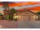 Charming two-story home boasts a spacious three-car garage and well-manicured desert landscaping at 3805 E Desert Flower Ln, Phoenix, AZ 85044