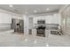 Bright kitchen featuring stainless appliances, white cabinets, and light granite countertops at 3805 E Desert Flower Ln, Phoenix, AZ 85044