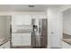 Kitchen with white cabinets and stainless steel refrigerator with water and ice dispenser at 3805 E Desert Flower Ln, Phoenix, AZ 85044