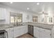 The kitchen featuring white cabinets, granite counters, and stainless steel dishwasher at 3805 E Desert Flower Ln, Phoenix, AZ 85044