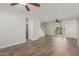 Inviting living room featuring wood-look flooring, ceiling fan, and staircase access at 3805 E Desert Flower Ln, Phoenix, AZ 85044