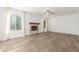Bright living room with charming fireplace, wood-look floors, ceiling fan, and natural light at 3805 E Desert Flower Ln, Phoenix, AZ 85044
