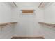 Spacious walk-in closet with wooden shelves and clothing rods providing ample storage space at 3805 E Desert Flower Ln, Phoenix, AZ 85044