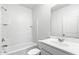 Bathroom featuring a tub/shower combo, white tile and a single sink vanity at 38099 N Stallion St, San Tan Valley, AZ 85140