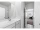 Bathroom vanity with sink and a mirror, plus view into a bedroom at 38099 N Stallion St, San Tan Valley, AZ 85140