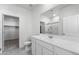 Clean bathroom featuring a white vanity with ample storage, a large mirror, and a glass-enclosed shower at 38099 N Stallion St, San Tan Valley, AZ 85140