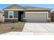 Charming single-story home with a gray exterior, stone accents, and a well-maintained front yard at 38099 N Stallion St, San Tan Valley, AZ 85140