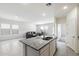 Open-concept kitchen showcasing stainless steel appliances, granite countertops, and a seamless transition to the living area at 38099 N Stallion St, San Tan Valley, AZ 85140