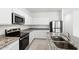 Well-equipped kitchen featuring stainless steel appliances, granite countertops, and sleek white cabinetry at 38099 N Stallion St, San Tan Valley, AZ 85140