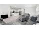 Open-concept living room showcasing modern gray furniture, plush carpeting, and a seamless transition to the kitchen at 38099 N Stallion St, San Tan Valley, AZ 85140