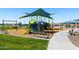 A colorful community playground with slides, swings, and benches for parents at 38099 N Stallion St, San Tan Valley, AZ 85140