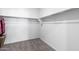 An ample walk-in closet, with neutral carpeting, rod and shelf; perfect for storage at 38099 N Stallion St, San Tan Valley, AZ 85140