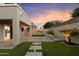 Beautiful backyard features a manicured lawn, lovely pavers, lush landscaping, and ambient lighting at 3932 S Crosscreek Dr, Chandler, AZ 85286
