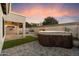 Relaxing backyard featuring a modern hot tub, pavers, and artificial grass at 3932 S Crosscreek Dr, Chandler, AZ 85286