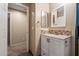 Cozy bathroom boasts a white vanity with a granite countertop, decorative backsplash, and a framed mirror at 3932 S Crosscreek Dr, Chandler, AZ 85286