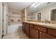 Bathroom with double sink vanity, decorative tile and a separate soaking tub and shower at 3932 S Crosscreek Dr, Chandler, AZ 85286