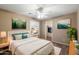 Comfortable bedroom featuring a ceiling fan, bright windows, and a walk-in closet for plenty of storage at 3932 S Crosscreek Dr, Chandler, AZ 85286
