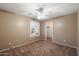 Neutral bedroom with carpet, a window with plantation shutters and a ceiling fan, and small walk in closet at 3932 S Crosscreek Dr, Chandler, AZ 85286