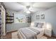 This charming bedroom boasts a ceiling fan, bright windows, and stylish shelving for a cozy retreat at 3932 S Crosscreek Dr, Chandler, AZ 85286