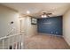 Upstairs bonus room features neutral carpet, ceiling fan and a blue accent wall with mounted television at 3932 S Crosscreek Dr, Chandler, AZ 85286