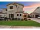 Charming two-story home with well-manicured lawn, lush landscaping, and neutral color palette at 3932 S Crosscreek Dr, Chandler, AZ 85286
