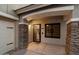 Covered front entryway, stone pillars, front door with black trim, and window at 3932 S Crosscreek Dr, Chandler, AZ 85286