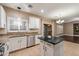 Well lit kitchen with white cabinets, granite countertops, stainless appliances, and a view to the Gathering room at 3932 S Crosscreek Dr, Chandler, AZ 85286