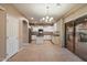 Bright kitchen with an island, granite countertops, stainless steel appliances, and sliding glass doors to backyard at 3932 S Crosscreek Dr, Chandler, AZ 85286