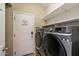 Modern laundry room features a side-by-side washer and dryer, and convenient storage shelves at 3932 S Crosscreek Dr, Chandler, AZ 85286