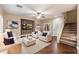 Open-concept staged living area with hardwood floors, a decorative fireplace, and a staircase at 3932 S Crosscreek Dr, Chandler, AZ 85286