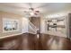 Open-concept living area into kitchen with hardwood floors, a staircase, and lots of natural light at 3932 S Crosscreek Dr, Chandler, AZ 85286