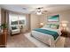 Bedroom featuring a bed, ceiling fan, and a comfortable chair with an accent pillow at 3932 S Crosscreek Dr, Chandler, AZ 85286