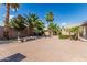 Tropical backyard featuring brick pavers, fire pit, and lush landscaping with tropical palms at 4336 W Hackamore Dr, Phoenix, AZ 85083