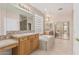 Bathroom with vanity, jacuzzi tub, a glass block window, and tiled floor for relaxation at 4336 W Hackamore Dr, Phoenix, AZ 85083