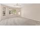 Spacious bedroom with neutral carpet, ceiling fan, and natural light from the multiple windows at 4336 W Hackamore Dr, Phoenix, AZ 85083