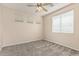 Carpeted bedroom with fan, window, and neutral walls at 4336 W Hackamore Dr, Phoenix, AZ 85083