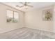 This bedroom features a ceiling fan and a window with blinds at 4336 W Hackamore Dr, Phoenix, AZ 85083