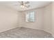 A carpeted bedroom features a ceiling fan and a window with blinds at 4336 W Hackamore Dr, Phoenix, AZ 85083